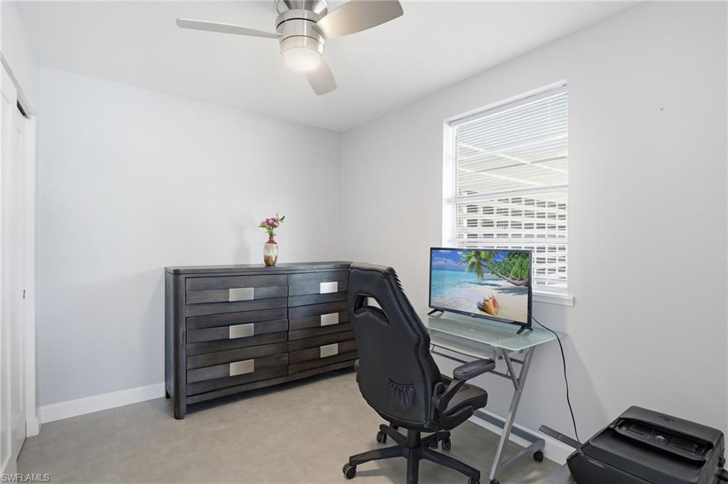 4518 West Alhambra Circle Naples, FL 34103 - Photo 37 of 40 a room that has a dresser and a chair