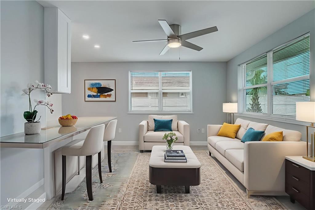 4518 West Alhambra Circle Naples, FL 34103 - Photo 4 of 40 a living room with furniture and a large window