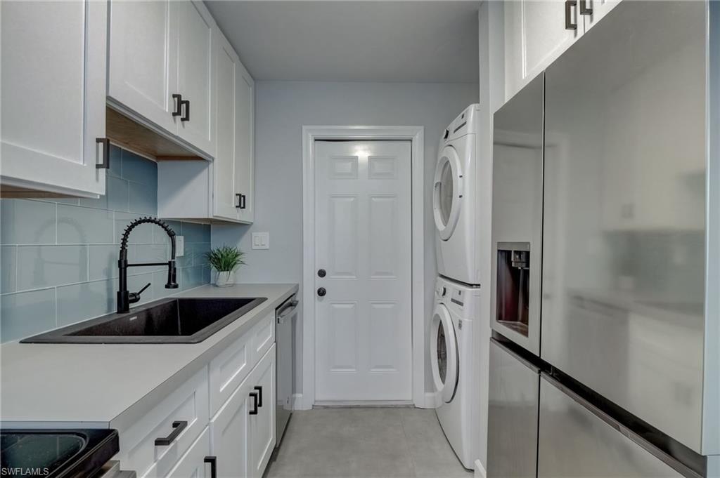 4518 West Alhambra Circle Naples, FL 34103 - Photo 7 of 40 a kitchen with stainless steel appliances granite countertop a refrigerator and a sink