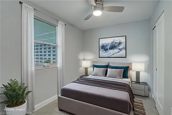 a bedroom with a large bed and a potted plant