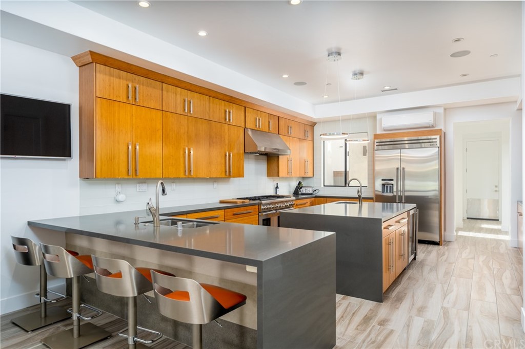 237 1st Street Huntington Beach, CA 92648 - Photo 11 of 68 a kitchen with stainless steel appliances granite countertop a sink and cabinets
