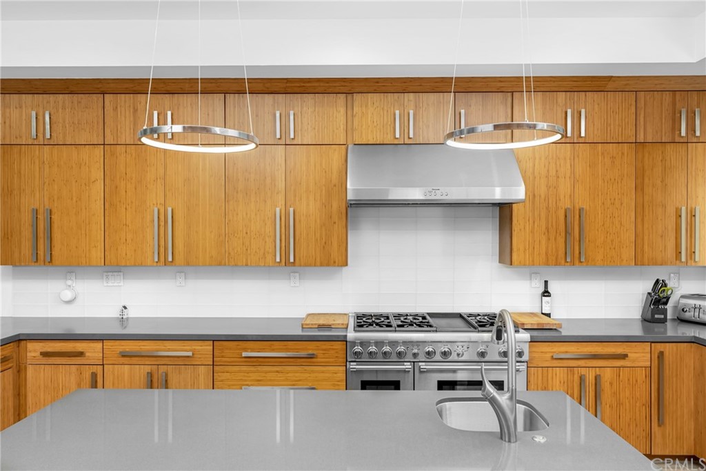 237 1st Street Huntington Beach, CA 92648 - Photo 12 of 68 a kitchen with stainless steel appliances granite countertop a sink and cabinets