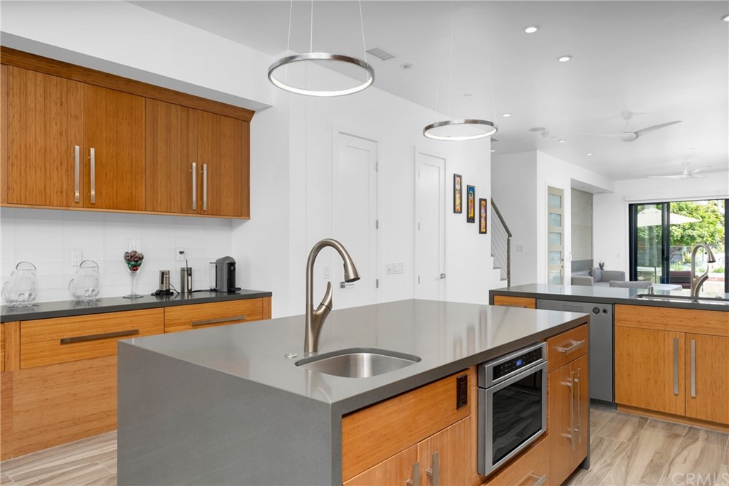 237 1st Street Huntington Beach, CA 92648 - Photo 13 of 68 a kitchen with stainless steel appliances granite countertop a sink stove and cabinets