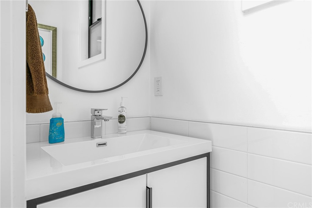 237 1st Street Huntington Beach, CA 92648 - Photo 14 of 68 a bathroom with a sink and a mirror