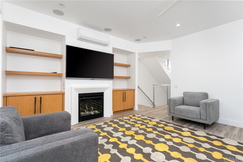 237 1st Street Huntington Beach, CA 92648 - Photo 15 of 68 a living room with furniture a flat screen tv and a fireplace