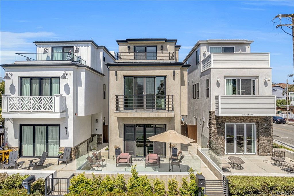 237 1st Street Huntington Beach, CA 92648 - Photo 2 of 68 a front view of a house with yard and sitting area