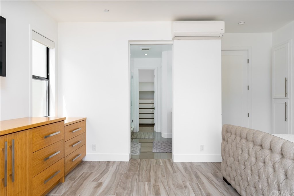 237 1st Street Huntington Beach, CA 92648 - Photo 22 of 68 a view of hallway with stairs and wooden floor