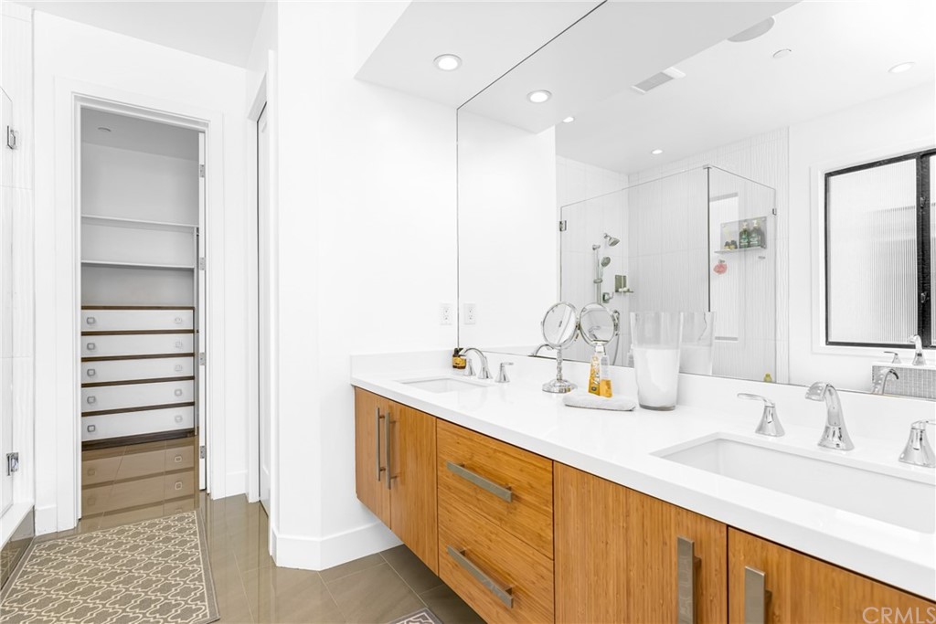 237 1st Street Huntington Beach, CA 92648 - Photo 24 of 68 a spacious bathroom with a double vanity sink a and a mirror
