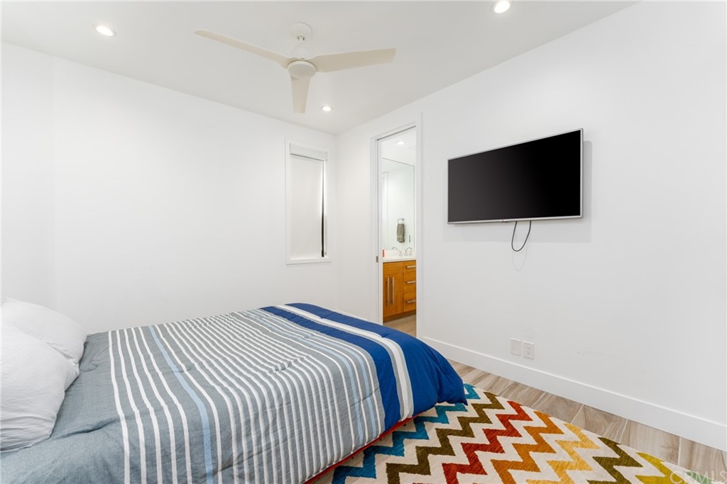 237 1st Street Huntington Beach, CA 92648 - Photo 29 of 68 a bedroom with a bed and a flat screen tv