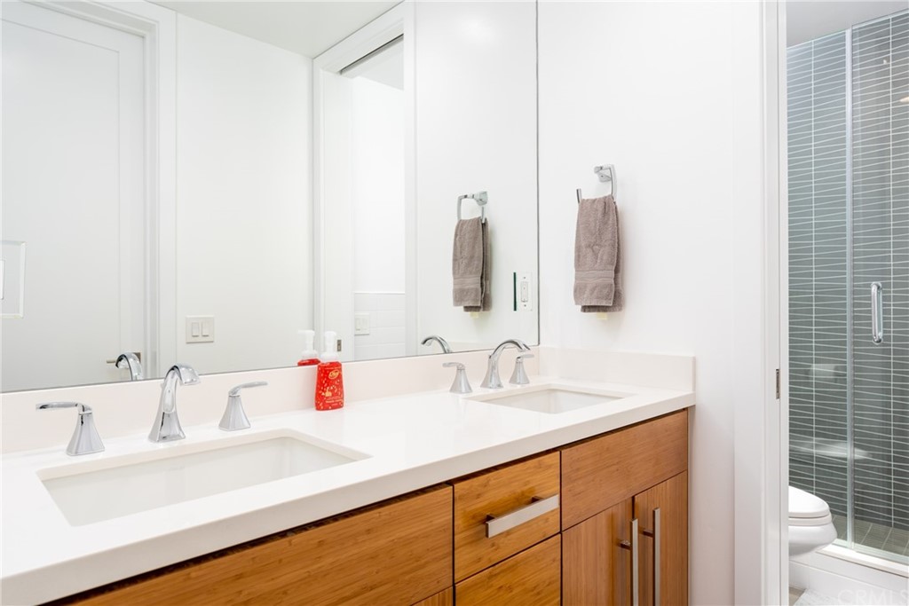 237 1st Street Huntington Beach, CA 92648 - Photo 30 of 68 a bathroom with a sink and a mirror