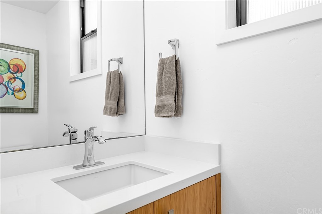 237 1st Street Huntington Beach, CA 92648 - Photo 33 of 68 a bathroom with a sink and a mirror