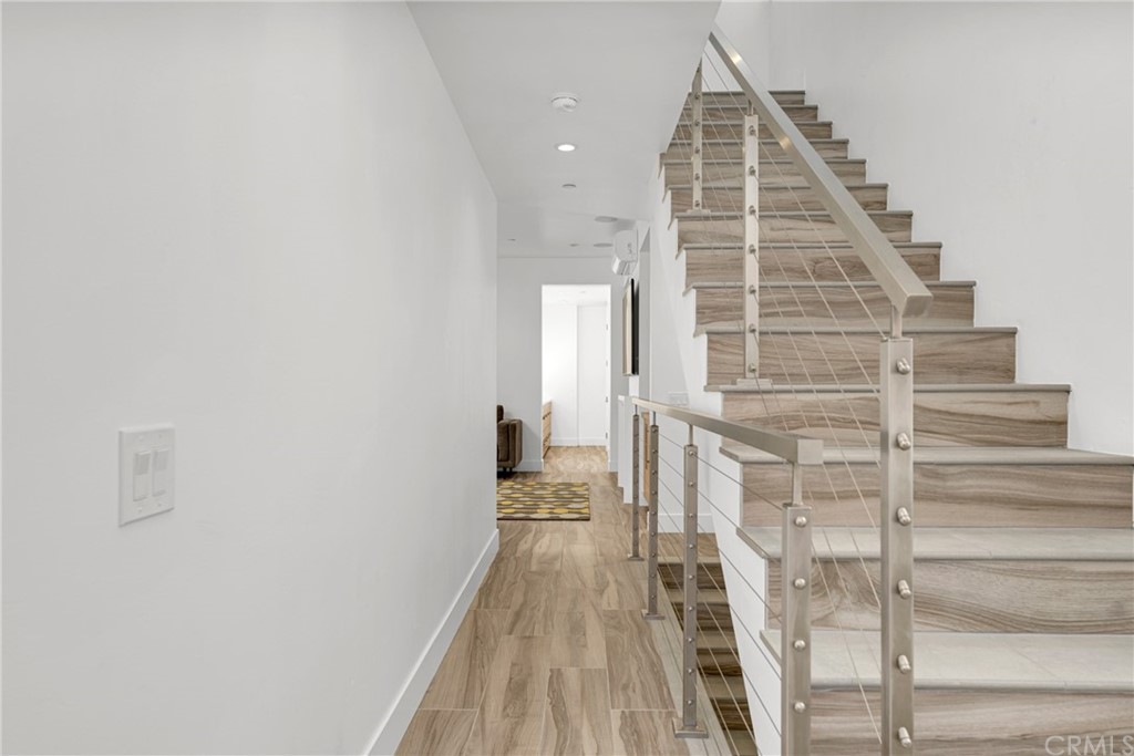 237 1st Street Huntington Beach, CA 92648 - Photo 34 of 68 a view of staircase with white walls and windows