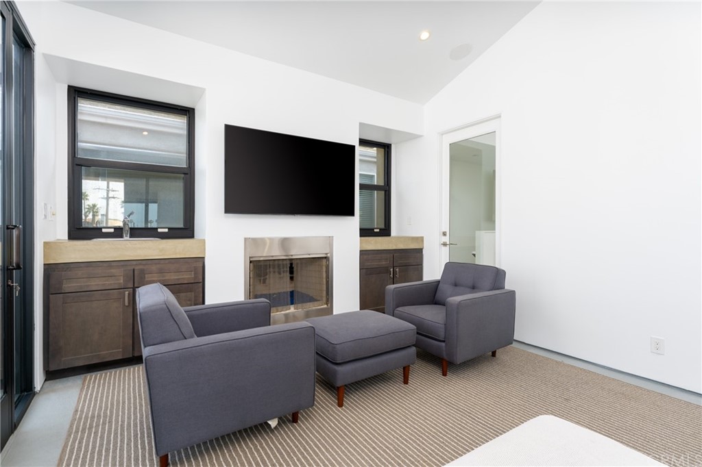 237 1st Street Huntington Beach, CA 92648 - Photo 43 of 68 a living room with furniture a fireplace and a flat screen tv