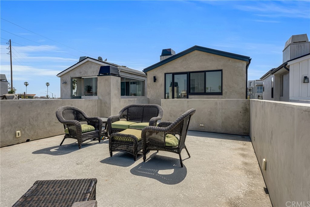 237 1st Street Huntington Beach, CA 92648 - Photo 47 of 68 a backyard of a house with table and chairs