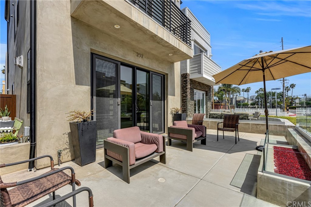 237 1st Street Huntington Beach, CA 92648 - Photo 6 of 68 a outdoor space with patio the couches and pool table under an umbrella