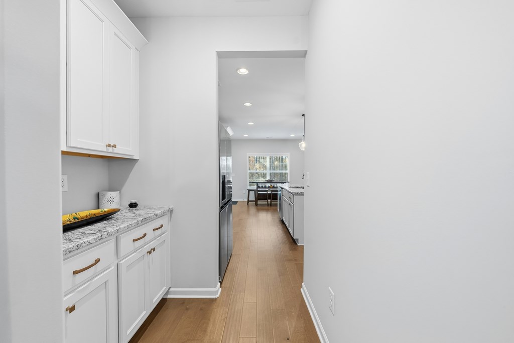 274 James Creek Road Fortson, GA 31808 - Photo 14 of 59 a hallway with white cabinets and wooden floor