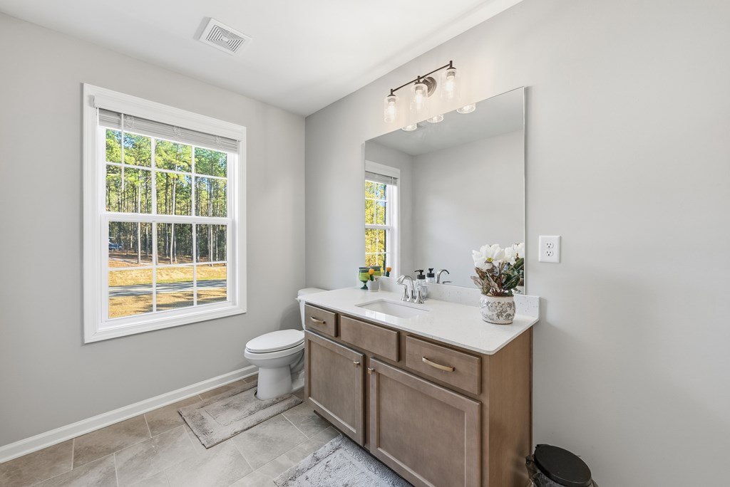 274 James Creek Road Fortson, GA 31808 - Photo 37 of 59 a bathroom with a sink vanity mirror and toilet