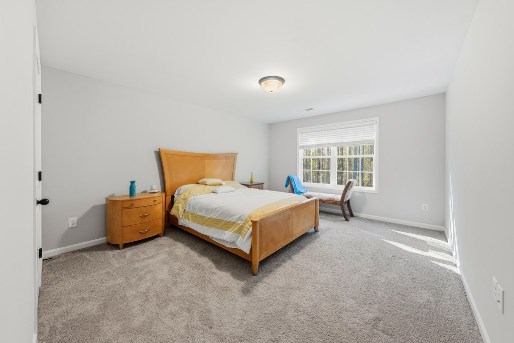 274 James Creek Road Fortson, GA 31808 - Photo 42 of 59 a bedroom with a bed and wooden floor
