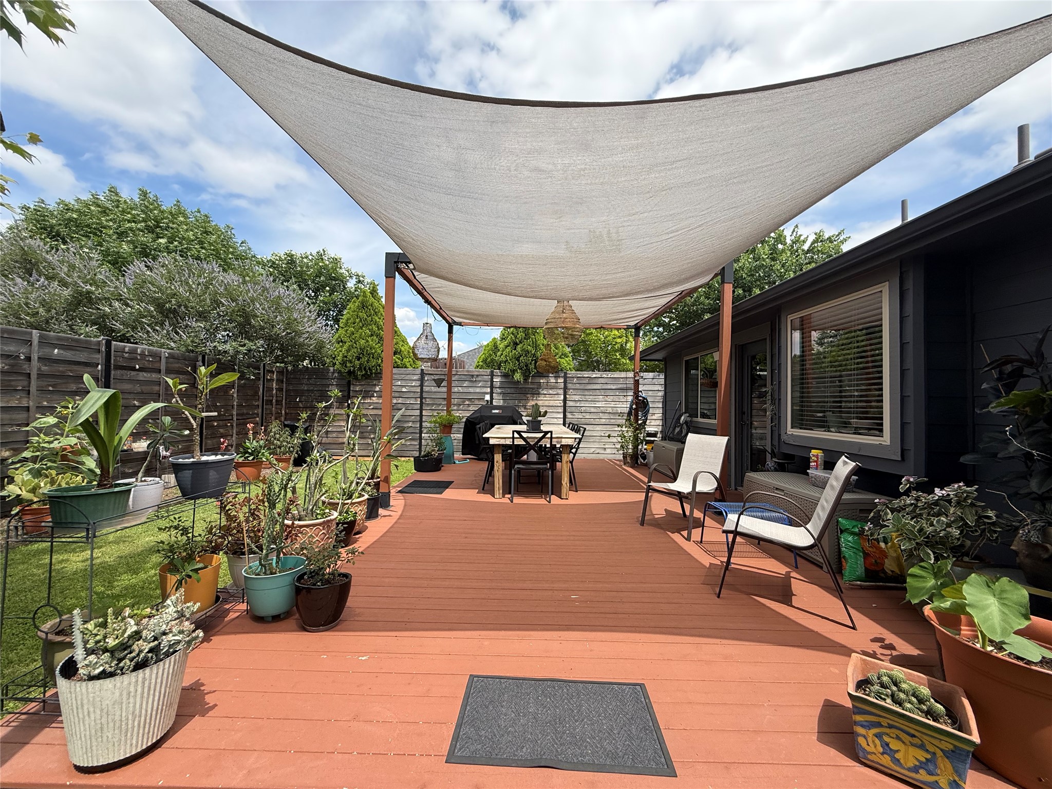 7108 Hester Road Austin, TX 78725 - Photo 17 of 25 a view of a patio with table and chairs potted plants and floor to ceiling window