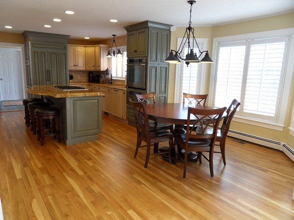 3 Clarks Hill Drive Sutton, MA 01590 - Photo 8 of 30 a kitchen with stainless steel appliances kitchen island granite countertop a table chairs and a refrigerator