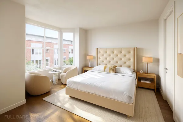 a bedroom with a bed and a large window