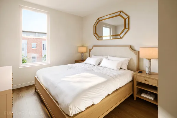 a bedroom with a bed and a window