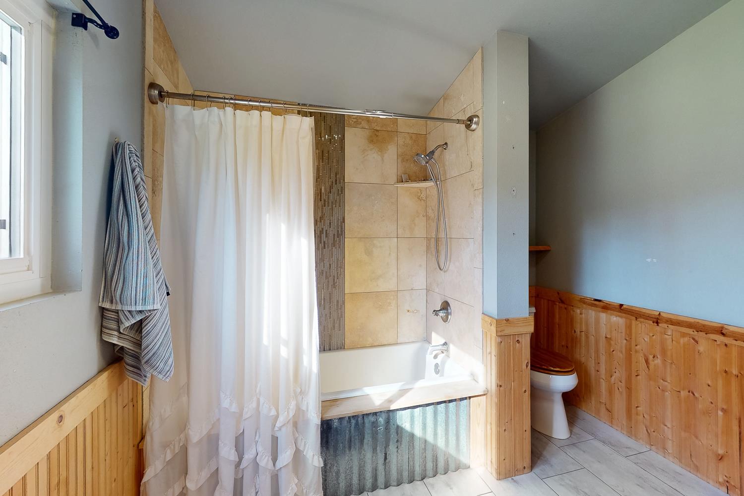 10146 Frenchtown Dobbins Road Dobbins, CA 95935 - Photo 12 of 38 a bathroom with a shower curtain and a sink