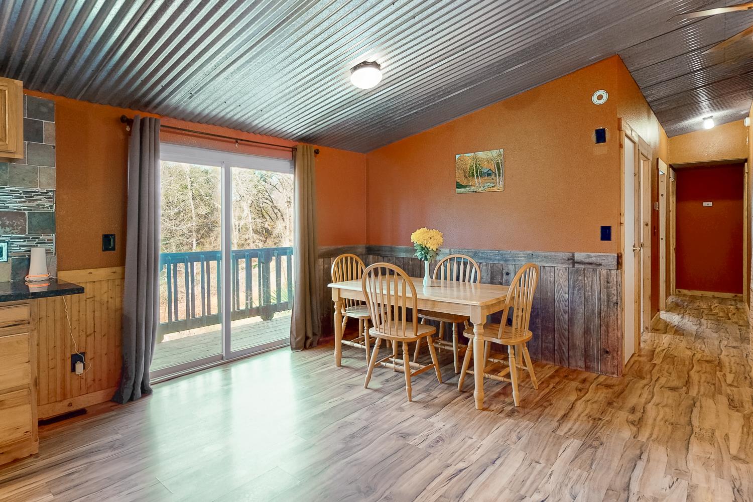10146 Frenchtown Dobbins Road Dobbins, CA 95935 - Photo 8 of 38 a dining room with furniture a chandelier and wooden floor