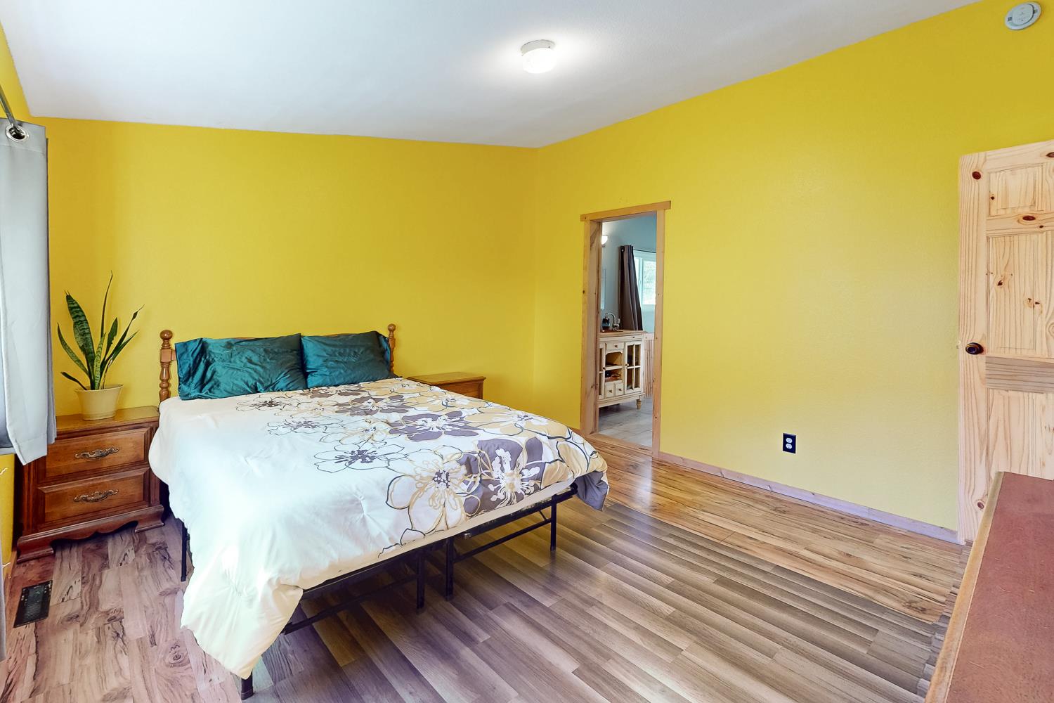 10146 Frenchtown Dobbins Road Dobbins, CA 95935 - Photo 9 of 38 a bedroom with a bed and wooden floor