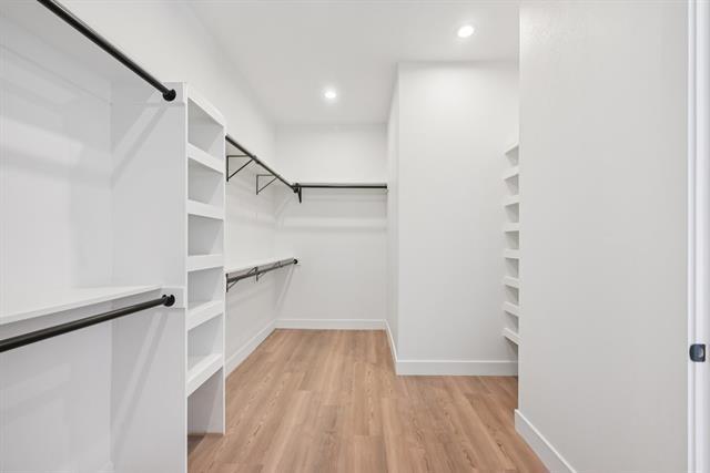 2936 Henry Road Lancaster, TX 75134 - Photo 16 of 28 Wood-finish flooring, recessed lighting, built-in shelving, and black rod hanging systems
