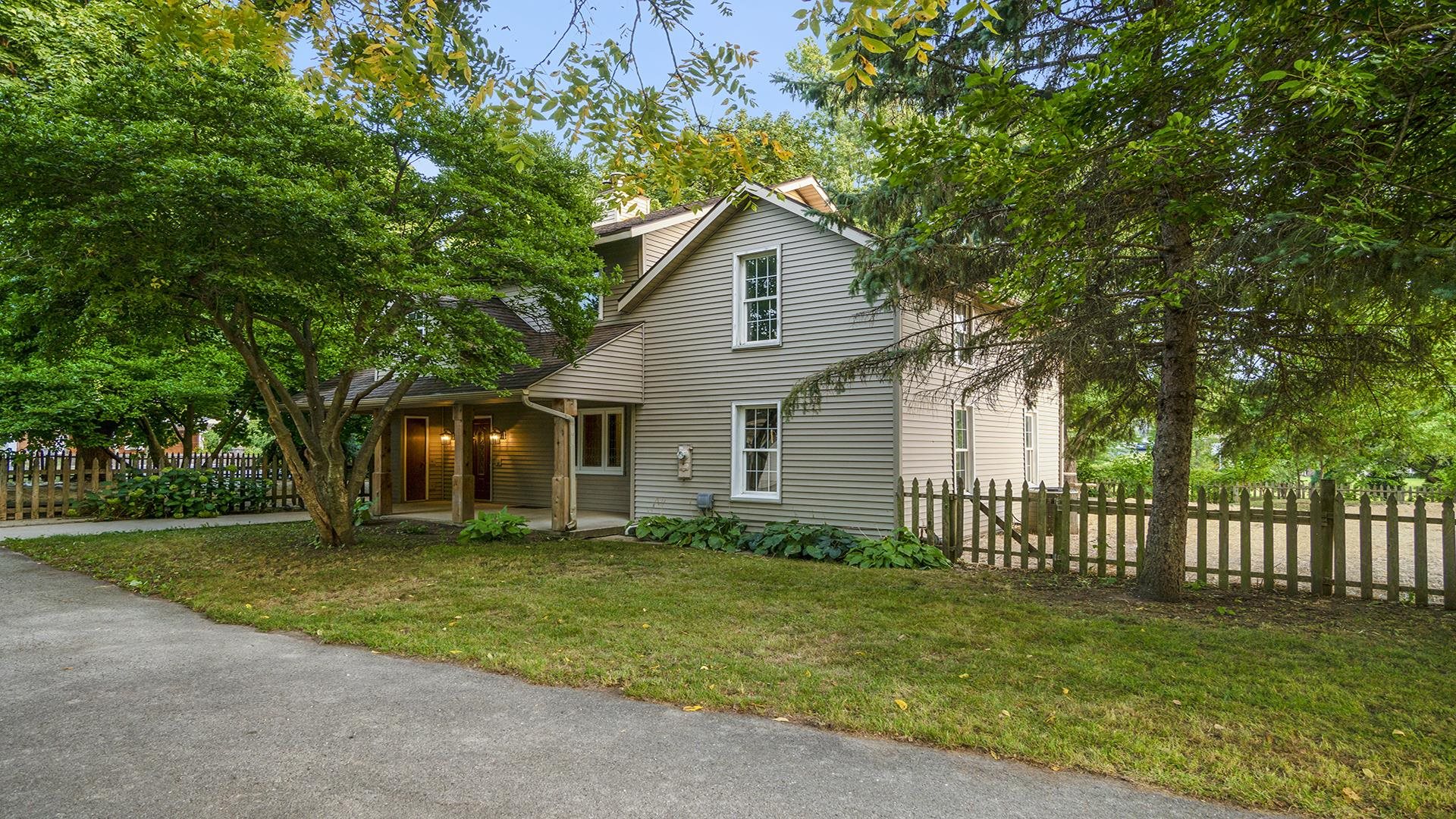 a front view of house with yard and green space