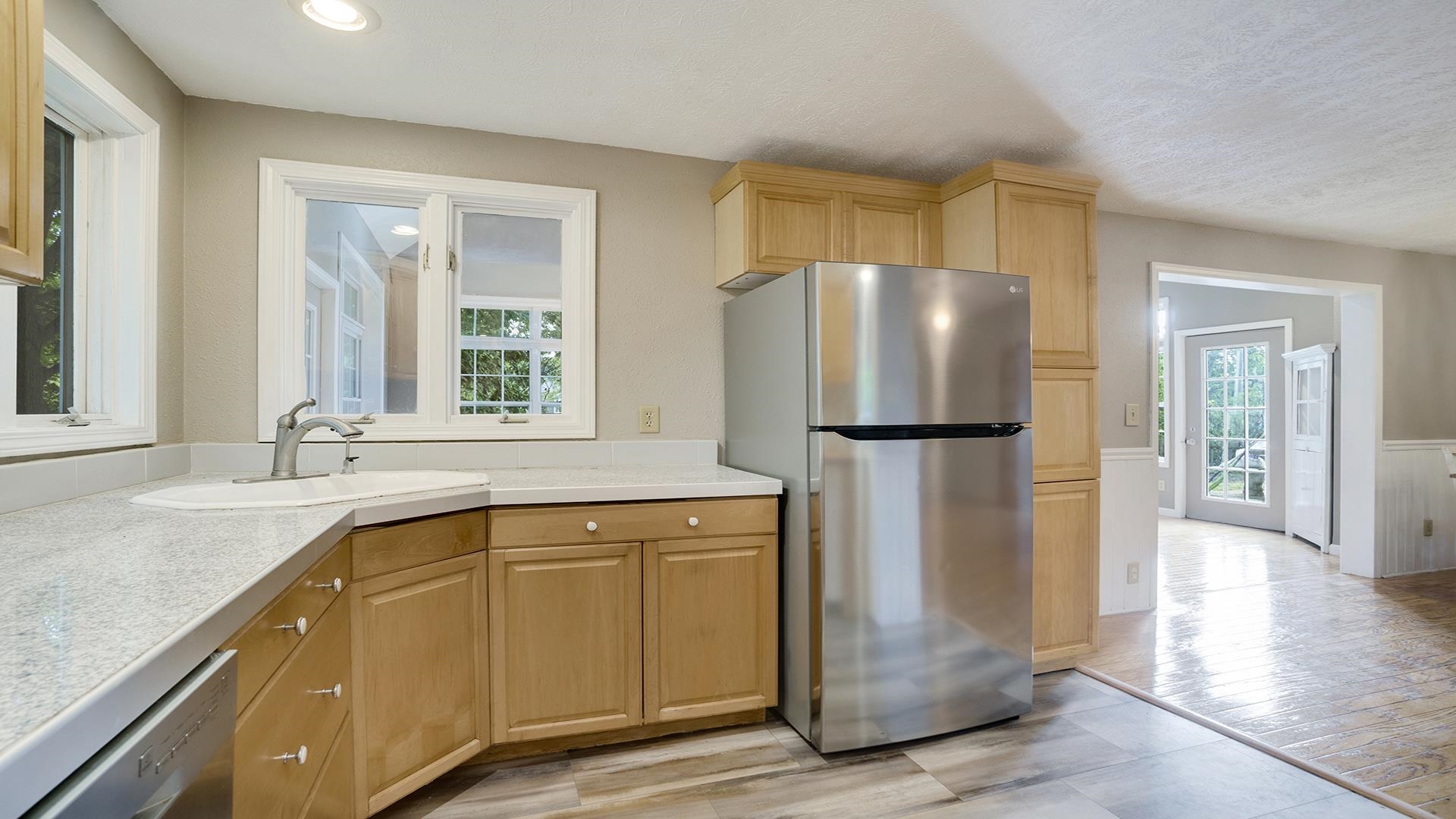 11501 Love Road Roscoe, IL 61073 - Photo 19 of 49 a kitchen with a refrigerator a sink and cabinets