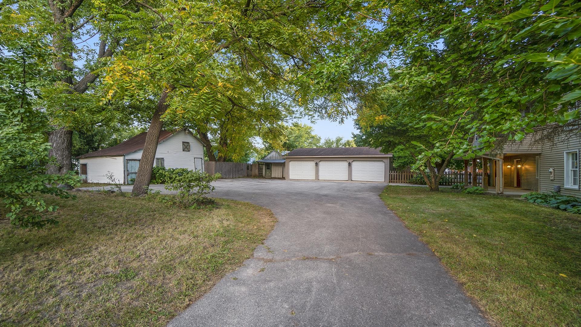 11501 Love Road Roscoe, IL 61073 - Photo 2 of 49 a front view of a house with a yard and a garage