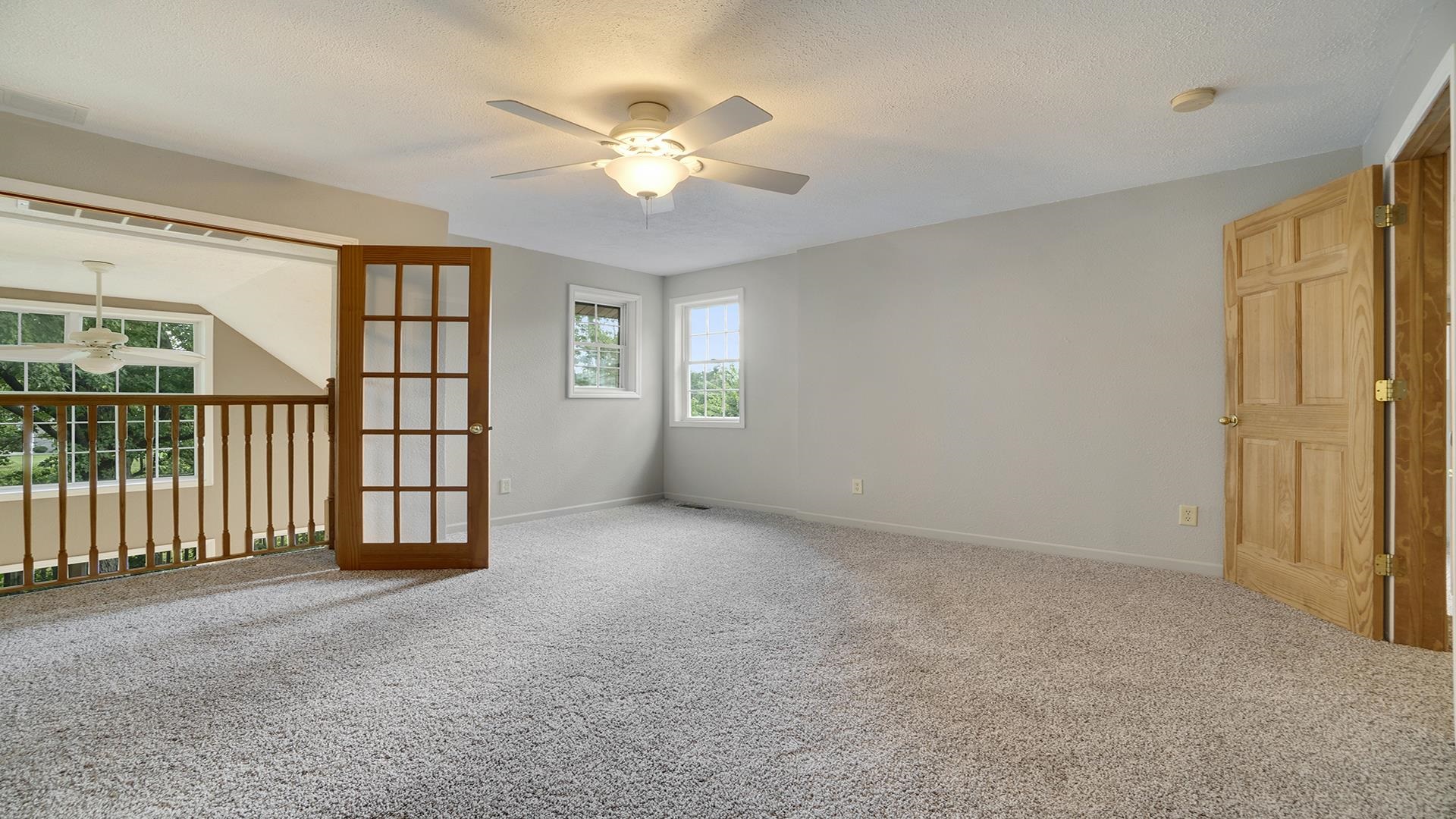 11501 Love Road Roscoe, IL 61073 - Photo 39 of 49 an empty room with chandelier fan and windows