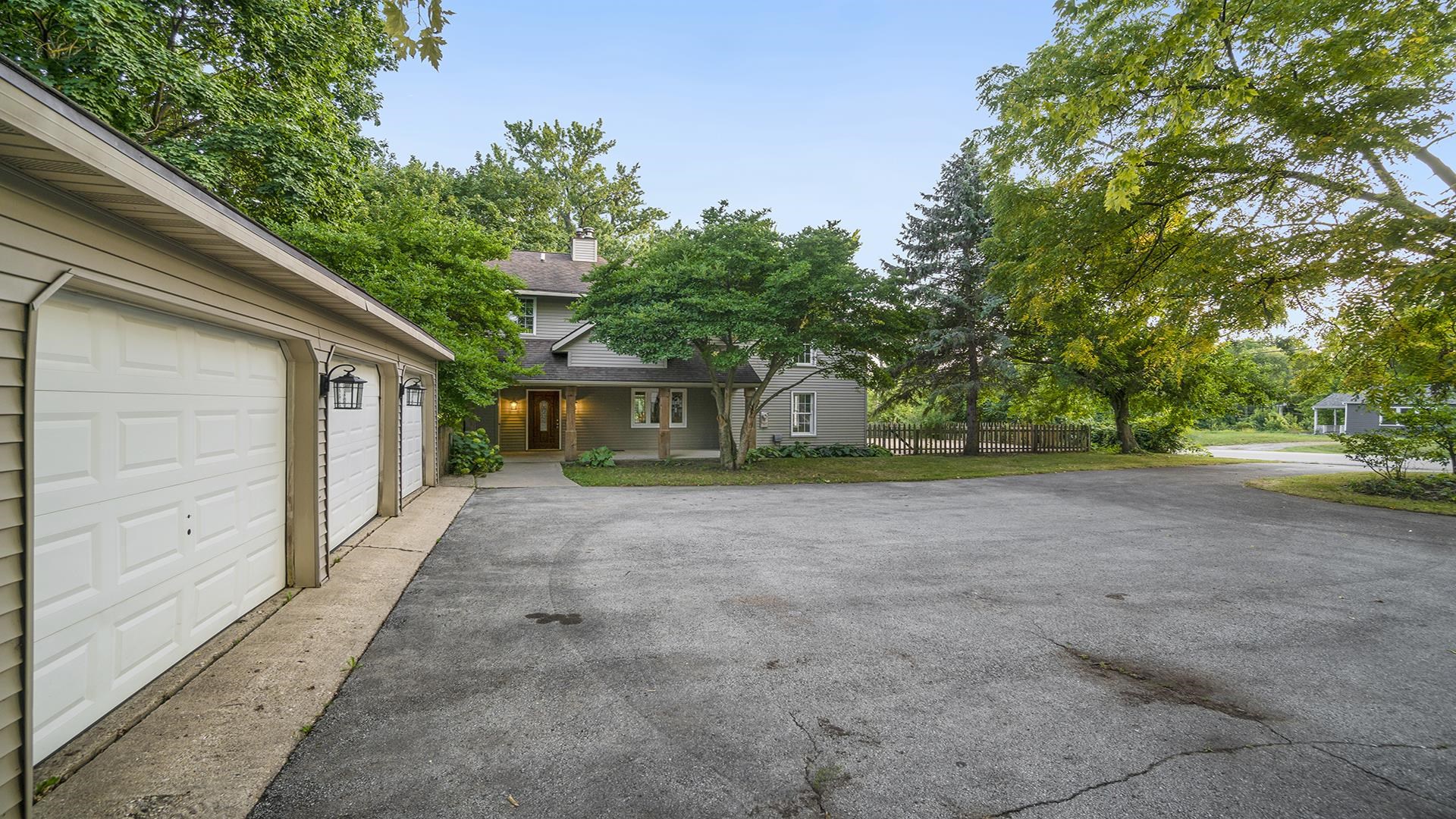11501 Love Road Roscoe, IL 61073 - Photo 4 of 49 a front view of a house with a yard and trees