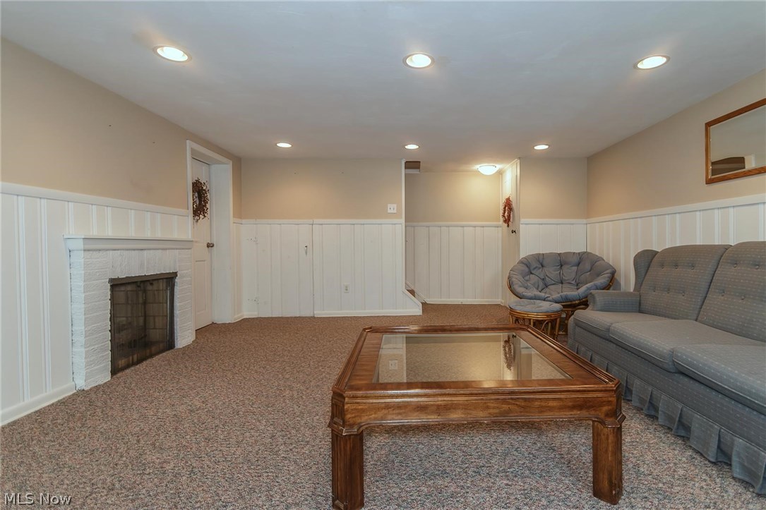 1143 Brainard Road Lyndhurst, OH 44124 - Photo 23 of 35 Family room in basement with carpeting and gas fireplace and plenty of storage.