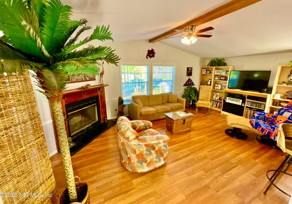 a bedroom with furniture and a flat screen tv