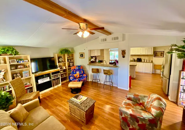 a living room with furniture and a book shelf