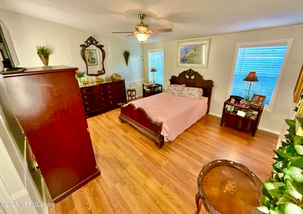 a bed room with a bed window and dresser
