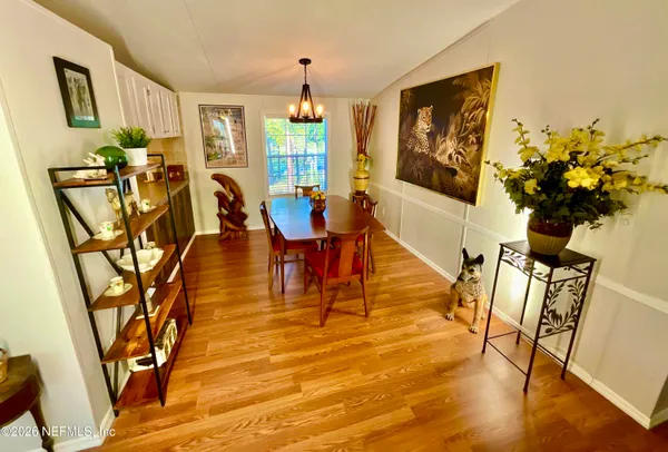 a kitchen with cabinets and wooden floor