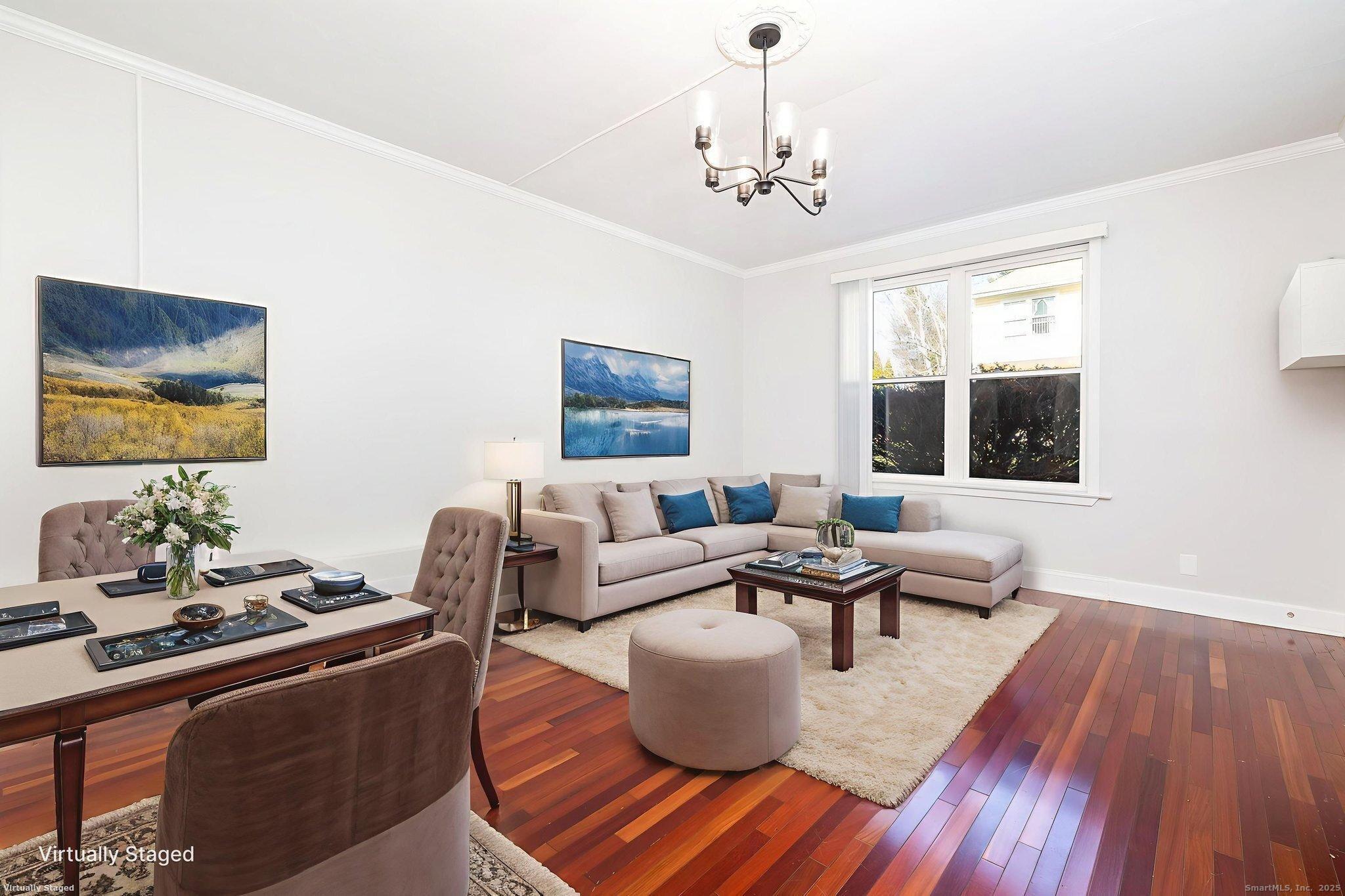 a living room with furniture and a chandelier