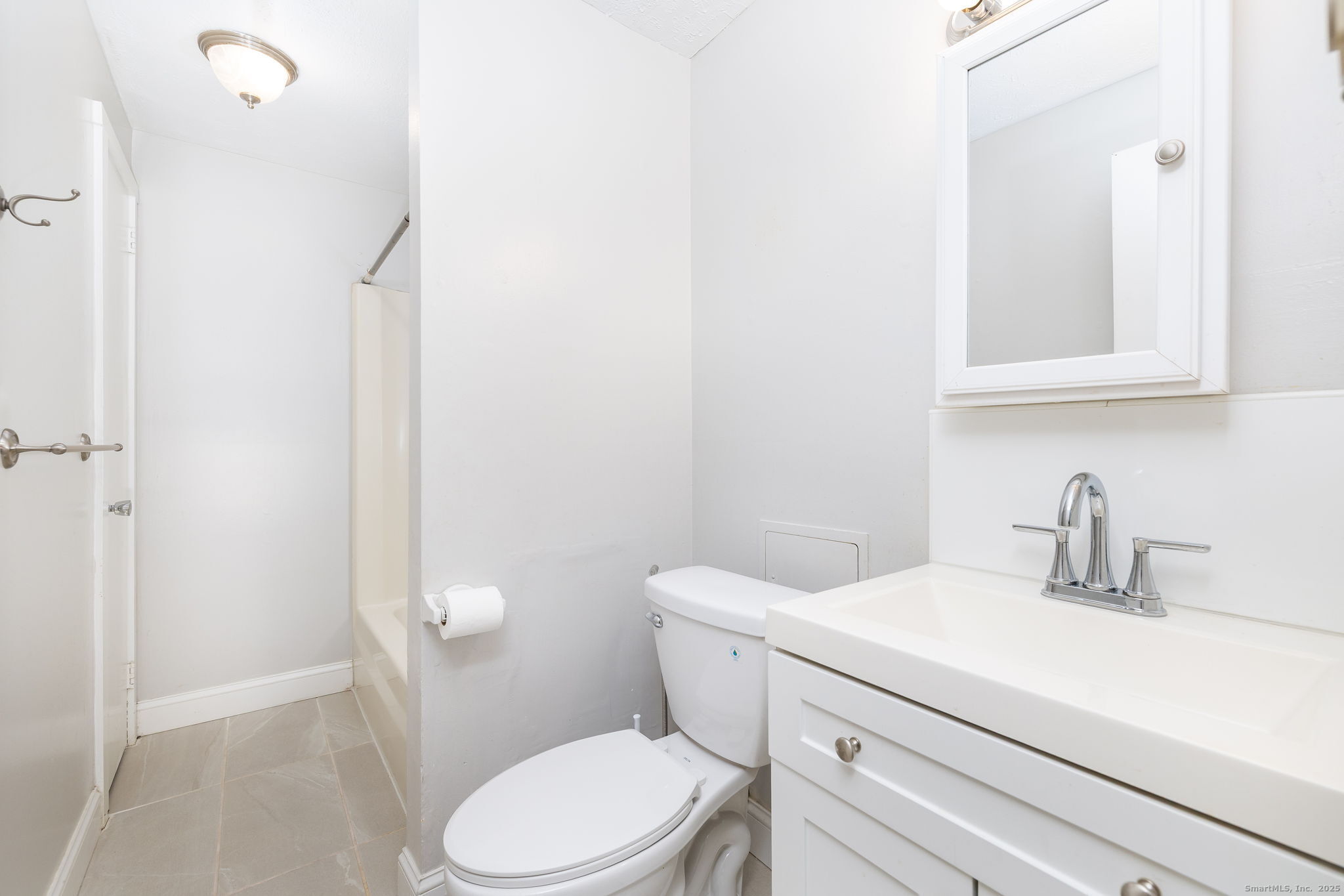 949 Pleasant Valley Road, Unit 801 South Windsor, CT 06074 - Photo 12 of 22 a bathroom with a sink a toilet and a mirror
