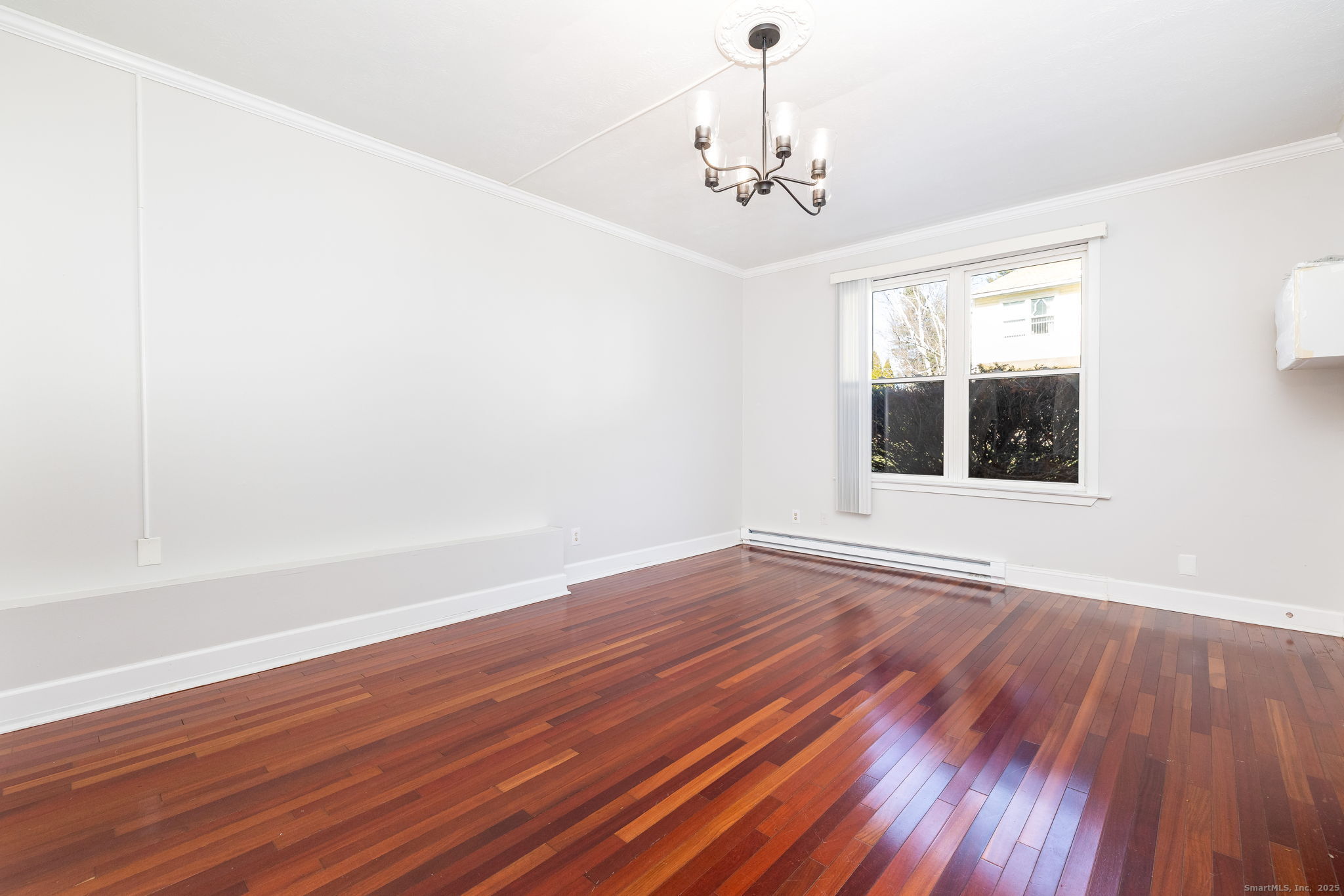 949 Pleasant Valley Road, Unit 801 South Windsor, CT 06074 - Photo 2 of 22 a view of an empty room with wooden floor and a window