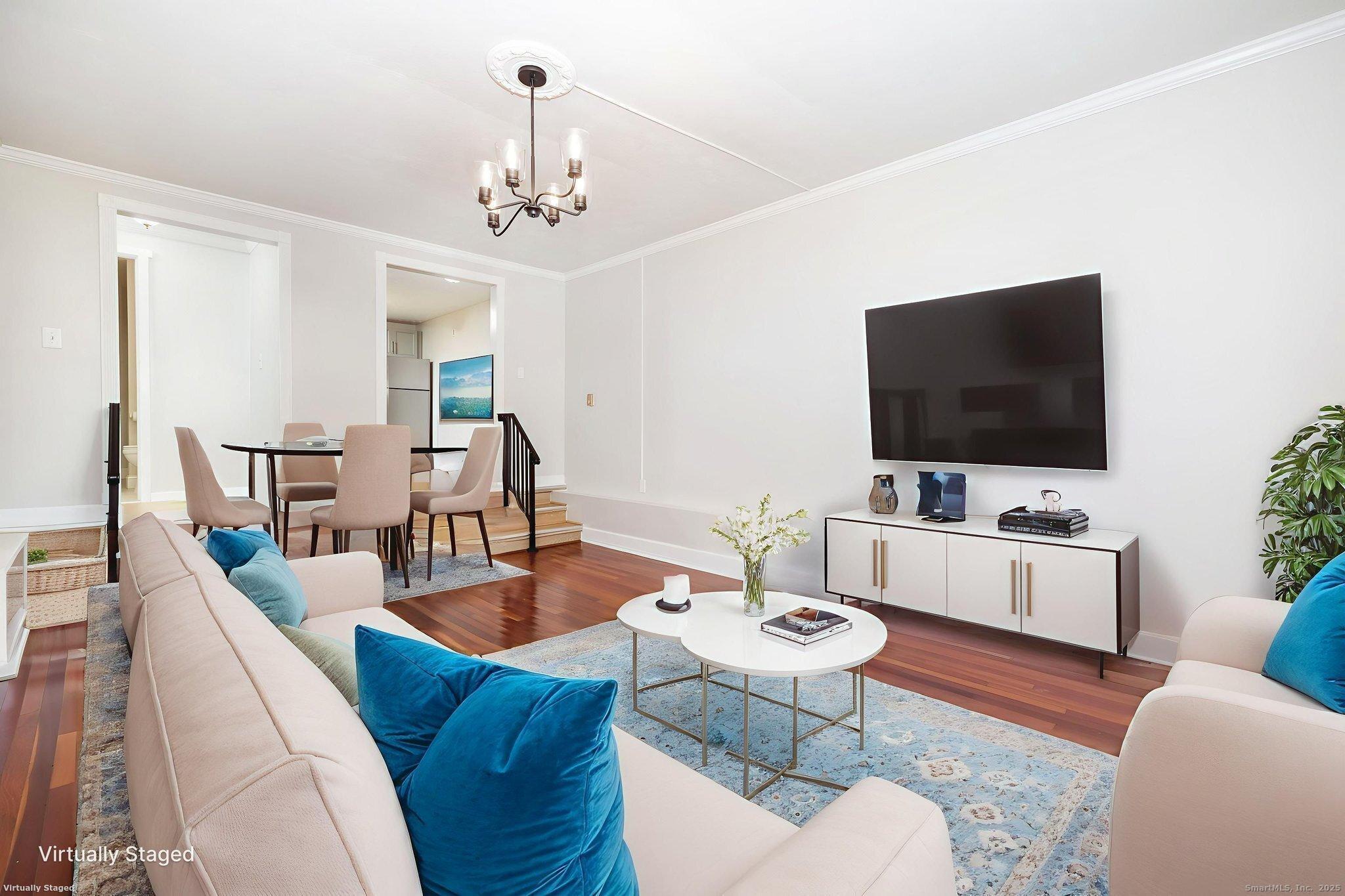 949 Pleasant Valley Road, Unit 801 South Windsor, CT 06074 - Photo 5 of 22 a living room with furniture a chandelier and a flat screen tv