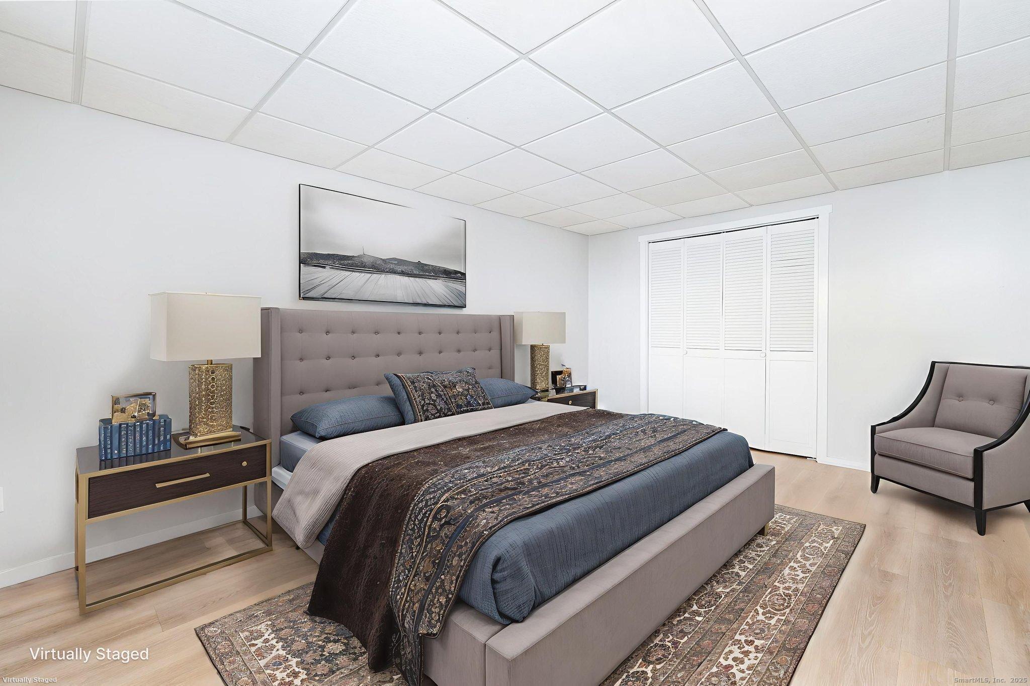 949 Pleasant Valley Road, Unit 801 South Windsor, CT 06074 - Photo 8 of 22 a bedroom with a bed and a couch