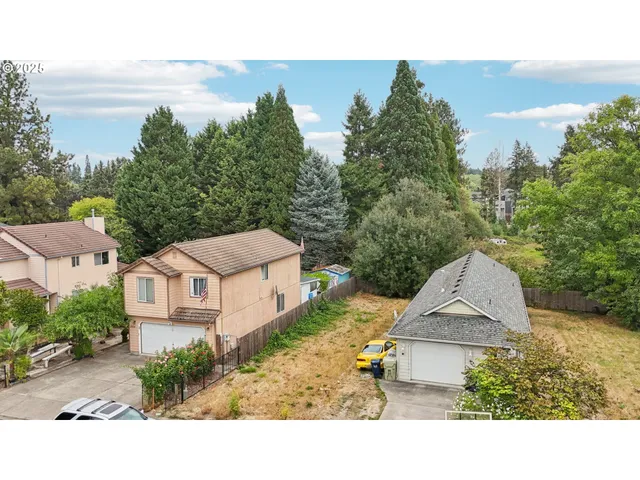 a aerial view of a house with a yard and balcony