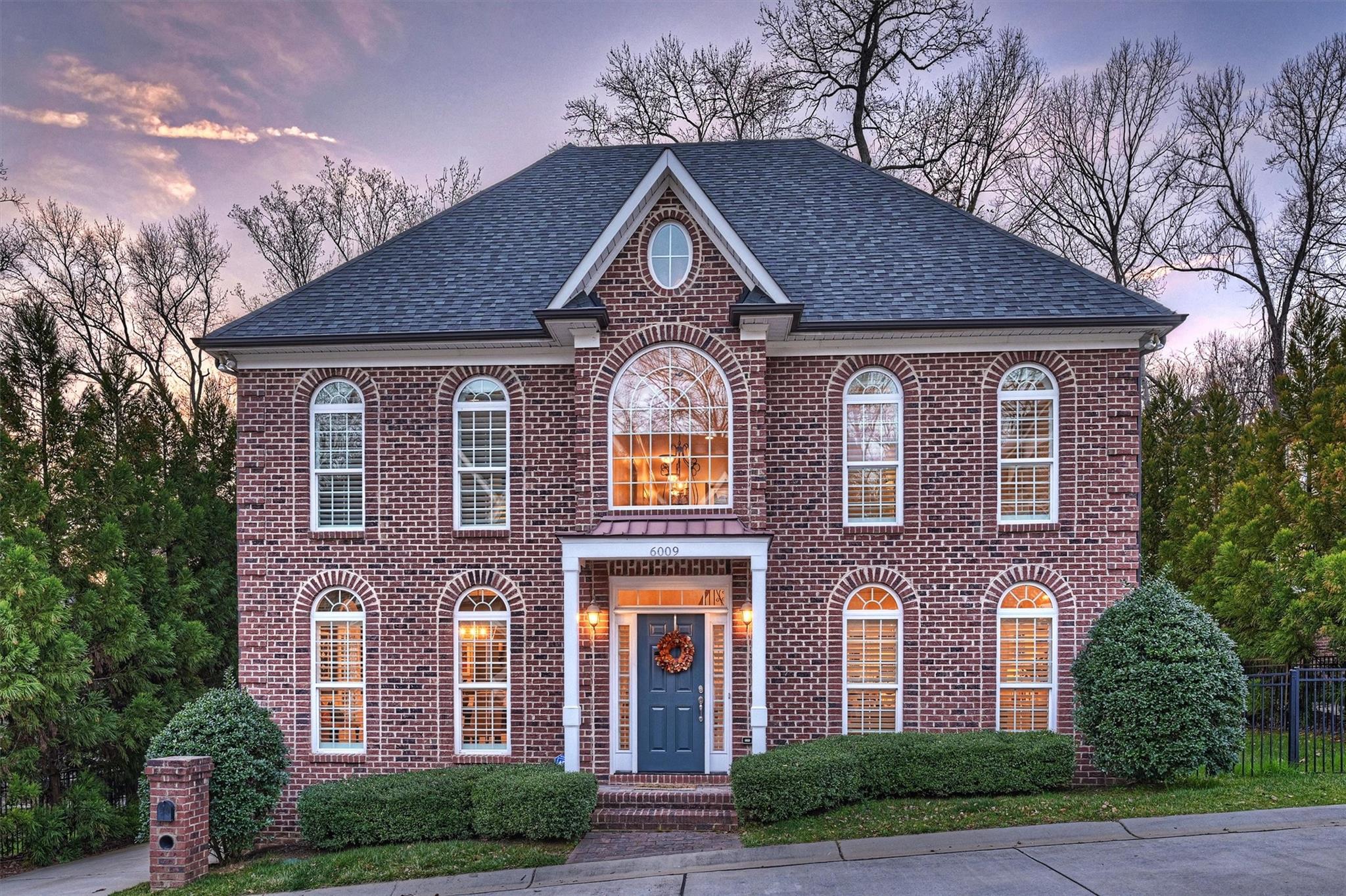 front view of brick house with a yard