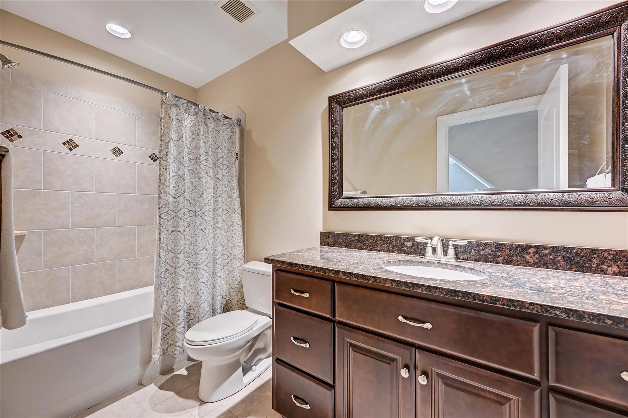 6009 Sharon View Road Charlotte, NC 28226 - Photo 21 of 47 a bathroom with a granite countertop sink toilet a mirror and bathtub