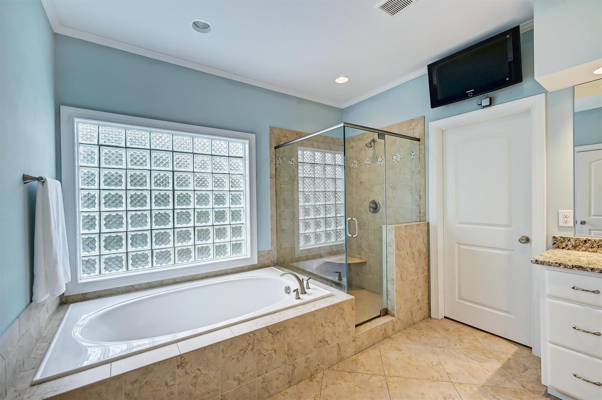 6009 Sharon View Road Charlotte, NC 28226 - Photo 29 of 47 a spacious bathroom with a tub a mirror and a shower