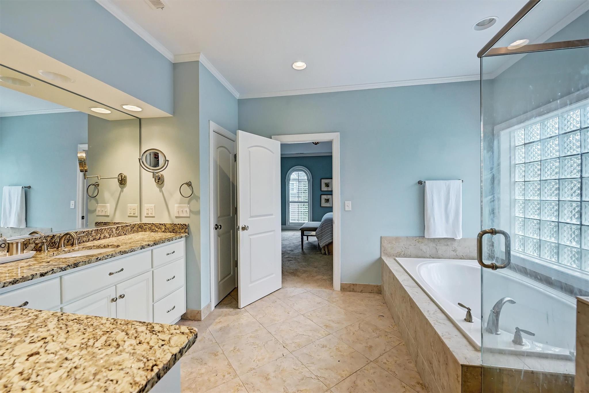 6009 Sharon View Road Charlotte, NC 28226 - Photo 31 of 47 a large bathroom with a tub sink and mirror